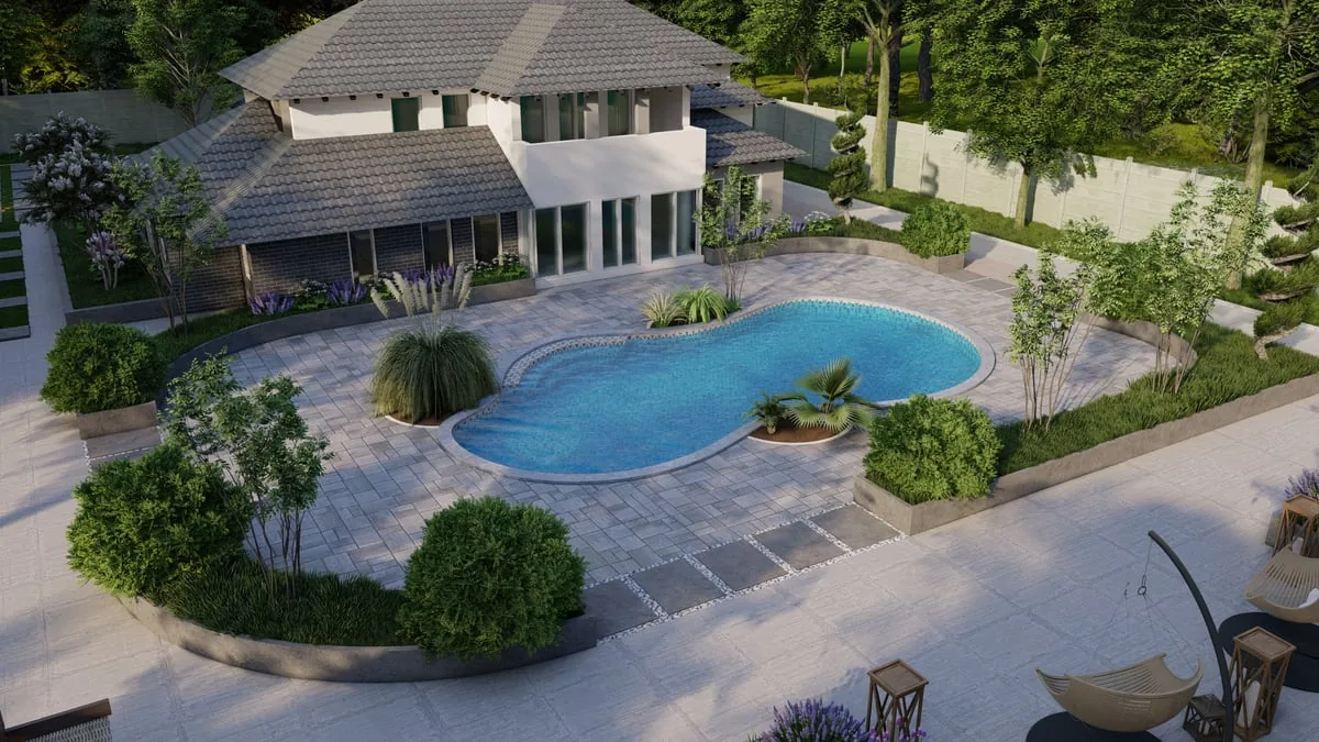 Paver pool deck with raised planting beds and ornamental grasses around a two-story house